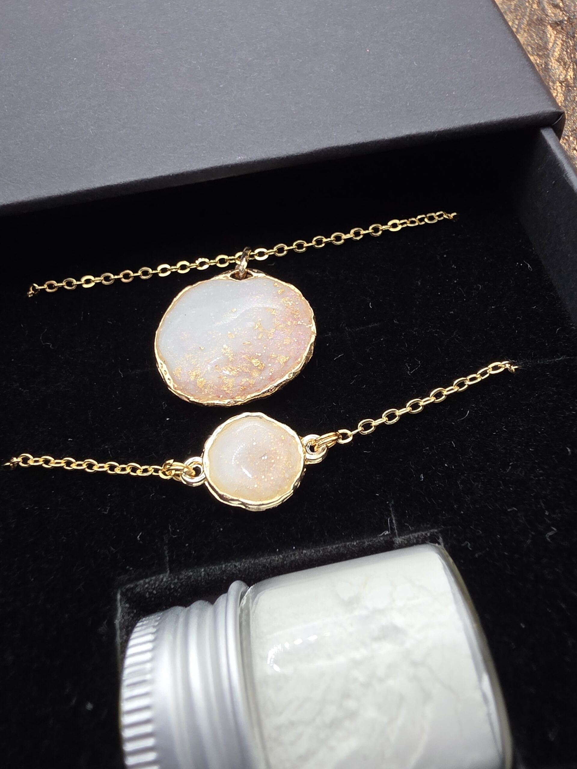 Two handmade keepsake pendants displayed together